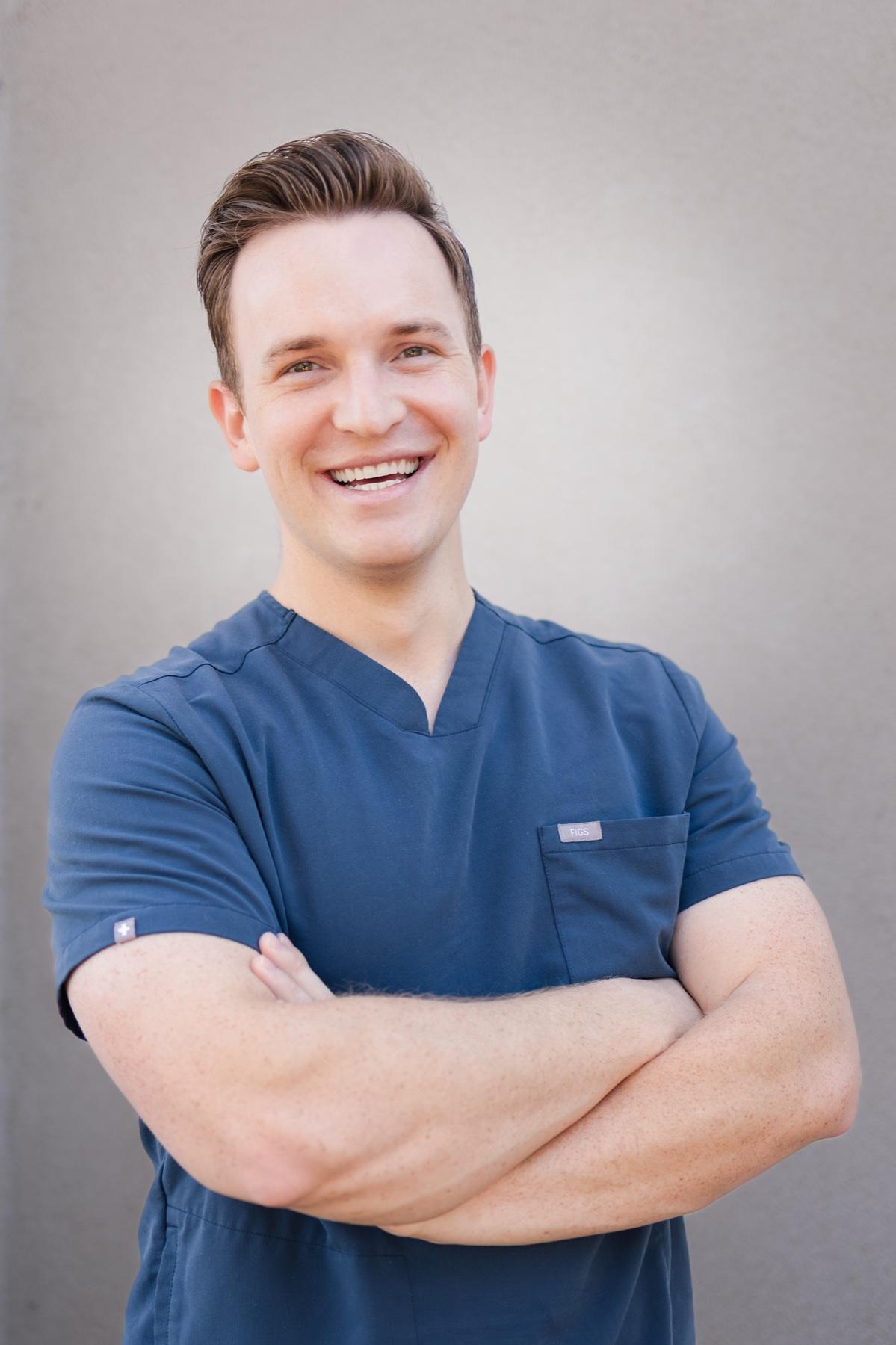 Dr. Mason Welch smiling in navy scrubs