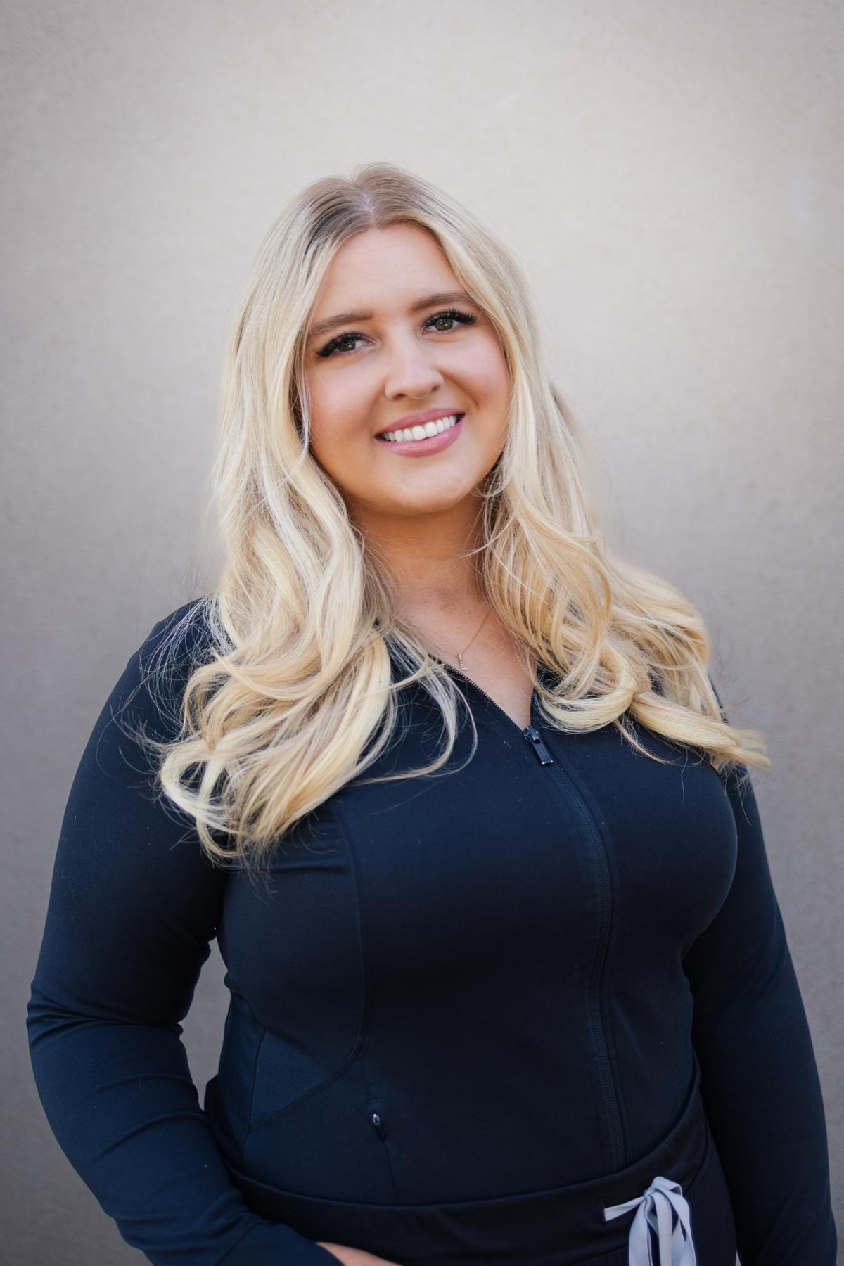 Lyric, Soft Shores office manager, smiling in a professional portrait